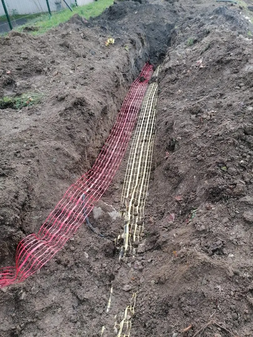 Tranchée extérieure avec grillages avertisseurs rouge et jaune